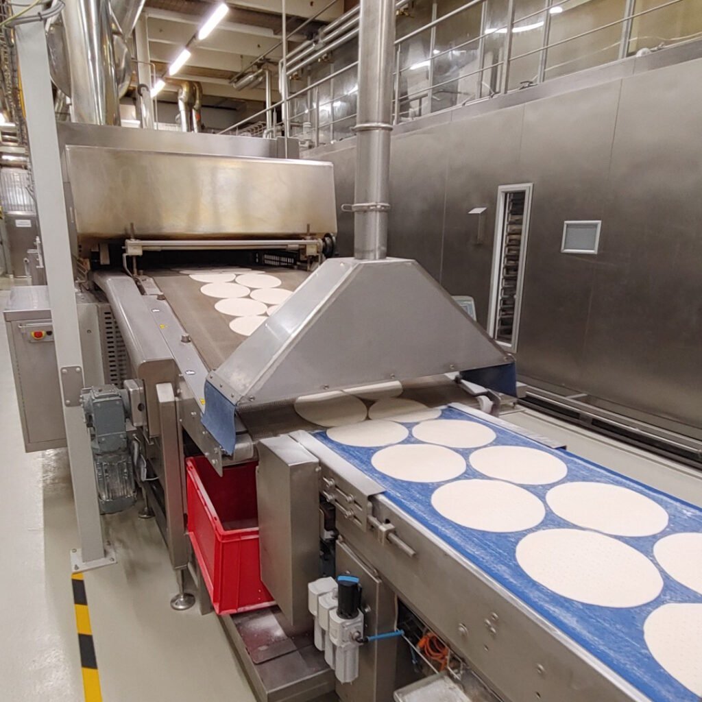 Línea de producción de pizza en grandes cantidades apoyada por un sistema de aspiración centralizado industrial